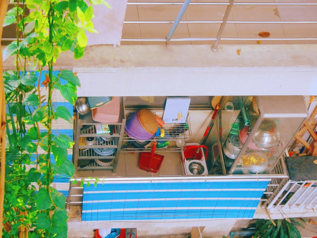 A stylish small living space with innovative storage solutions, showcasing organized shelves, multifunctional furniture, and a clutter-free environment.