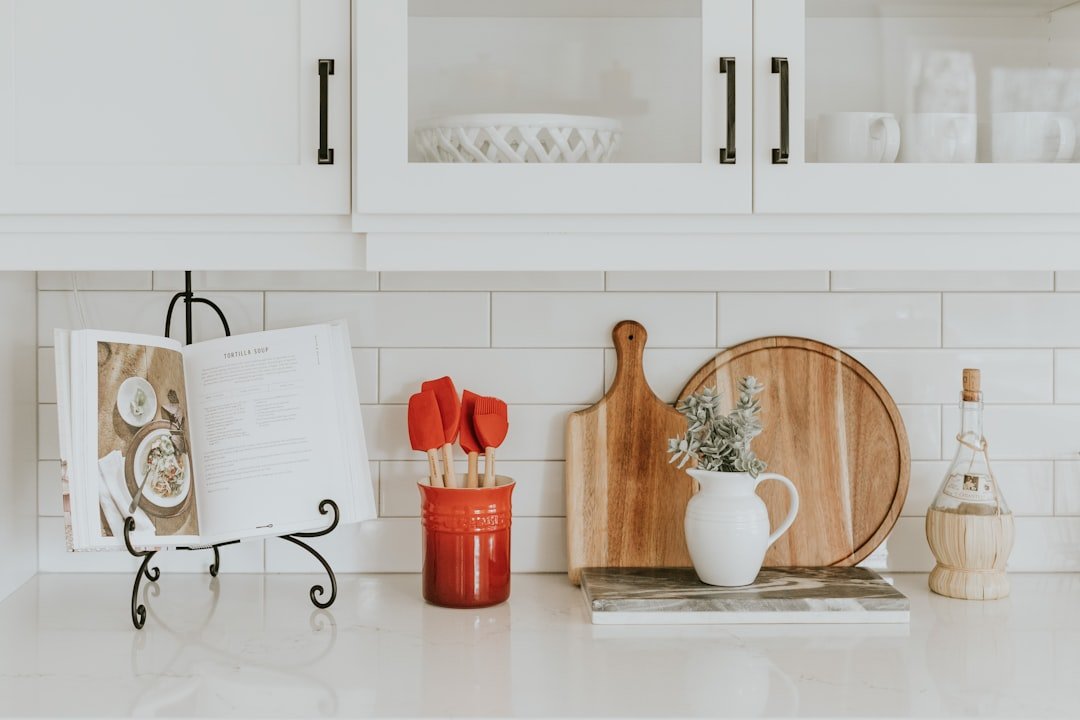 A well-organized kitchen with labeled storage containers, neatly arranged utensils, and a clean countertop.