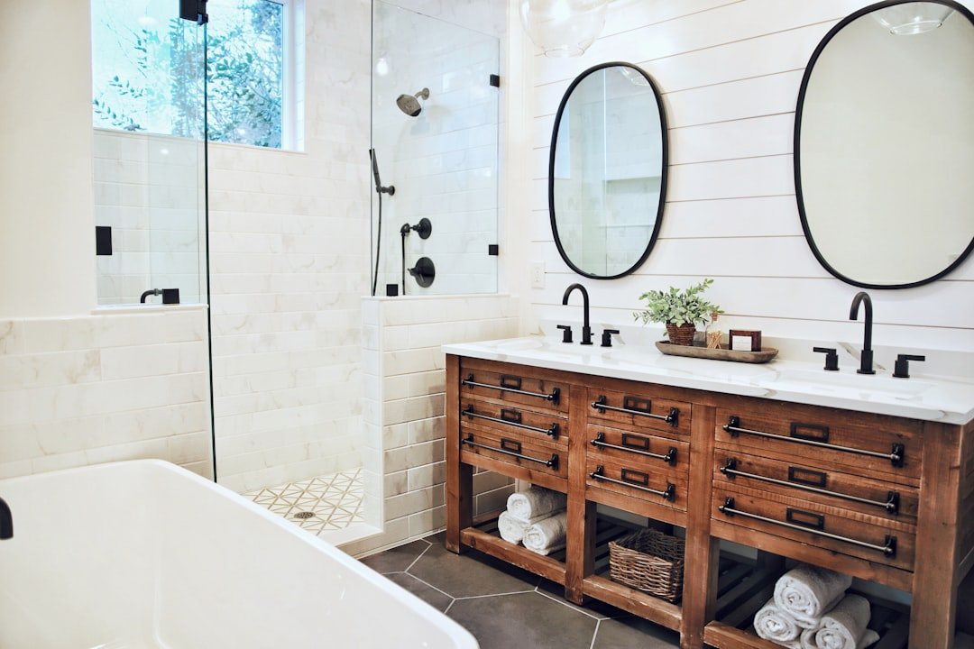 A neatly organized bathroom with minimal clutter, showcasing smart storage solutions like shelves, baskets, and hooks.