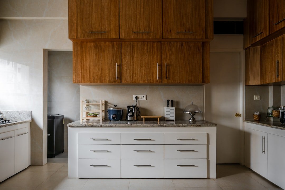 A neatly arranged kitchen cabinet showcasing organized dishes, pots, and pantry items, emphasizing a clean and efficient cooking space.