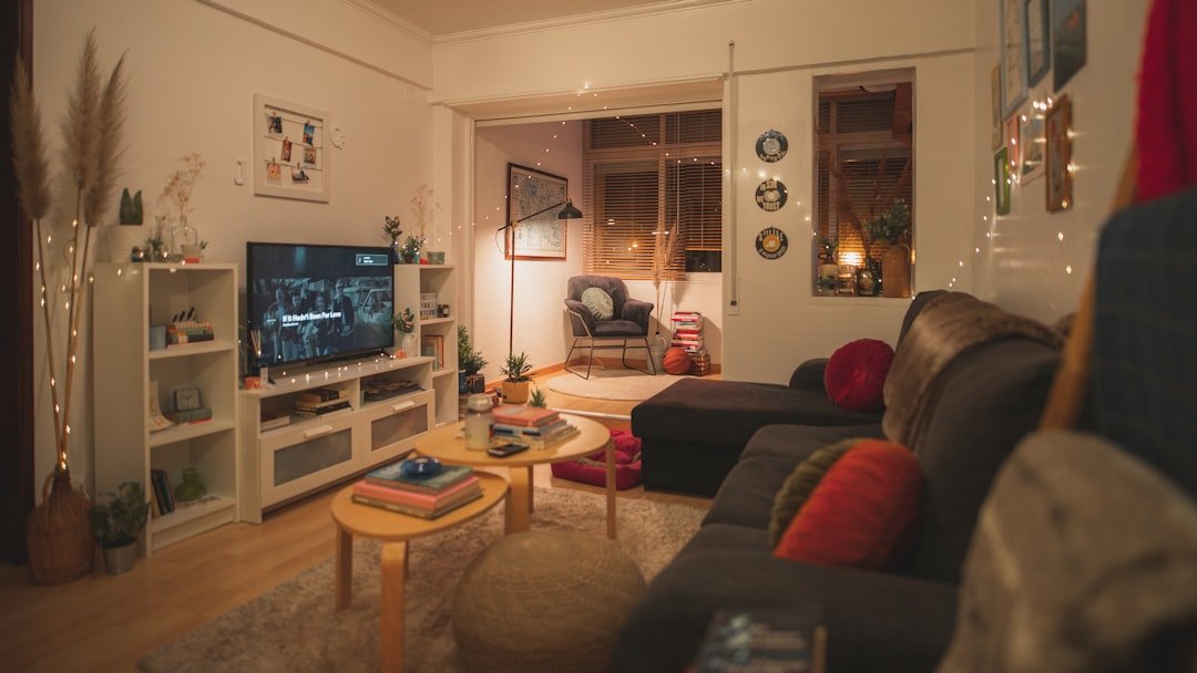 A warm and inviting living room with comfortable furniture, soft lighting, and organized space, showcasing a functional and cozy atmosphere.